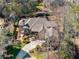 An aerial shot showcases a brick home with mature trees and a curving driveway at 3979 Sentry Xing, Marietta, GA 30068