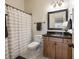 Standard bathroom with dark framed mirror, single bowl sink, and tub-shower combination at 3979 Sentry Xing, Marietta, GA 30068