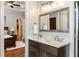 Bathroom with a single vanity, decorative mirror, and view into the main bedroom at 3979 Sentry Xing, Marietta, GA 30068