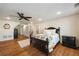 Bright bedroom with hardwood floors, ceiling fan, recessed lighting, white walls, and a dark wood bed set at 3979 Sentry Xing, Marietta, GA 30068