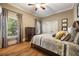 Bedroom featuring hardwood floors, double windows, and traditional decor at 3979 Sentry Xing, Marietta, GA 30068