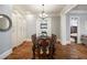 Formal dining room featuring hardwood floors, built-in cabinets, and a view into a cozy Gathering room at 3979 Sentry Xing, Marietta, GA 30068