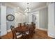 Dining room with hardwood floors, built-in cabinets, and view through a doorway into another room at 3979 Sentry Xing, Marietta, GA 30068