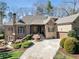 Traditional brick home with a curved driveway, attached garage, and mature landscaping at 3979 Sentry Xing, Marietta, GA 30068