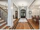 Spacious foyer with hardwood floors, grand staircase, elegant lighting, and decorative columns at 3979 Sentry Xing, Marietta, GA 30068