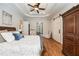 Bright main bedroom with hardwood floors, a ceiling fan, large windows, and access to a sitting area and ensuite bathroom at 3979 Sentry Xing, Marietta, GA 30068