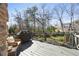 Outdoor deck with a built-in grill and a view of the backyard, surrounded by trees and greenery at 3979 Sentry Xing, Marietta, GA 30068