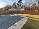 Backyard pool featuring a safety cover and a perimeter of well-maintained lawn at 921 Peel Castle Ln, Austell, GA 30106