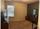 Bedroom with neutral carpet, natural light, and dark accent wall, creating a blank canvas for personalized décor at 1281 Rockfield Cir, Norcross, GA 30093