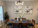 Dining area featuring a table set for six beneath a modern chandelier, creating a comfortable space for meals and gatherings at 1281 Rockfield Cir, Norcross, GA 30093