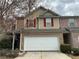 Attractive townhouse with a white garage door and red shutters at 1281 Rockfield Cir, Norcross, GA 30093