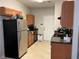 Well-lit kitchen featuring stainless steel refrigerator and standard appliances, creating a functional cooking space at 1281 Rockfield Cir, Norcross, GA 30093