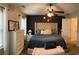 Cozy main bedroom features a tufted headboard and a ceiling fan with dark blue bedding at 1281 Rockfield Cir, Norcross, GA 30093