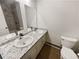 Well-lit bathroom with double sinks, granite countertop, and tiled shower/tub combo at 1444 Twin Branches Se Cir, Marietta, GA 30067
