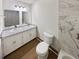 Elegant bathroom featuring double sinks, granite countertop, and tiled walls at 1444 Twin Branches Se Cir, Marietta, GA 30067