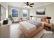 Cozy staged bedroom with neutral tones, plush rug, and large windows for natural light at 1444 Twin Branches Se Cir, Marietta, GA 30067