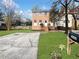 Charming two-story brick home featuring a landscaped front yard and a neatly paved driveway at 1444 Twin Branches Se Cir, Marietta, GA 30067