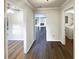 View of the hallway with hardwood floors leading to the living room and laundry area at 1444 Twin Branches Se Cir, Marietta, GA 30067