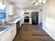 Modern kitchen featuring white cabinets, granite countertops, and stainless steel appliances at 1444 Twin Branches Se Cir, Marietta, GA 30067