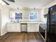 Bright kitchen featuring stainless steel appliances, white cabinets, and a stylish backsplash at 1444 Twin Branches Se Cir, Marietta, GA 30067