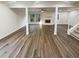 Open concept living room featuring a brick fireplace, hardwood floors, and stair access to the second floor at 1444 Twin Branches Se Cir, Marietta, GA 30067