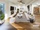 Bright living room with hardwood floors, fireplace, and stylish decor; staged for appeal at 1444 Twin Branches Se Cir, Marietta, GA 30067