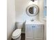 Cozy powder room with modern vanity, round decorative mirror, and white fixtures at 1444 Twin Branches Se Cir, Marietta, GA 30067