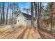 Back of a charming two-story home surrounded by trees and a grassy yard at 1780 Williams Cir, Cumming, GA 30041