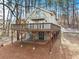 Charming two-story home with a large wooden deck and partially finished walk out basement on a wooded lot at 1780 Williams Cir, Cumming, GA 30041