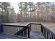 Backyard featuring a spacious deck overlooking a serene wooded area with mature trees at 460 Chandler Bluff Ct, Grayson, GA 30017