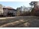 Expansive backyard features a two-story home with a deck, large lawn and view of the surrounding trees at 460 Chandler Bluff Ct, Grayson, GA 30017