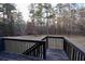 A large backyard with a wooden deck offers private outdoor living space and overlooks a dense forest at 460 Chandler Bluff Ct, Grayson, GA 30017