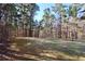 A lush backyard with mature trees offers privacy and shade, creating a serene oasis for relaxation at 460 Chandler Bluff Ct, Grayson, GA 30017