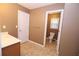 Cozy bathroom with tiled floor, single sink vanity, and private toilet room for added privacy at 460 Chandler Bluff Ct, Grayson, GA 30017