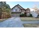 Charming two-story home with a manicured lawn, two-car garage and lovely architectural details at 460 Chandler Bluff Ct, Grayson, GA 30017