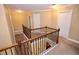 Upstairs hallway featuring neutral walls, carpeted floors and decorative railing at 460 Chandler Bluff Ct, Grayson, GA 30017