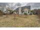 View of backyard with house featuring a dark roof and siding at 477 Harvick Cir, Stockbridge, GA 30281