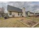 View of backyard with house featuring a dark roof and siding at 477 Harvick Cir, Stockbridge, GA 30281