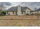 View of backyard with house featuring a dark roof and siding at 477 Harvick Cir, Stockbridge, GA 30281