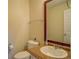 Cozy bathroom with cork counters, toilet and dark wooden framed mirror at 477 Harvick Cir, Stockbridge, GA 30281