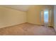 A tan bedroom features a vaulted ceiling and carpeted floor at 477 Harvick Cir, Stockbridge, GA 30281