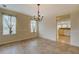 Dining area with chandelier lighting, tile floors, and view into bright kitchen at 477 Harvick Cir, Stockbridge, GA 30281