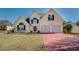 Beautiful two-story home with a driveway, featuring a well-kept lawn at 477 Harvick Cir, Stockbridge, GA 30281