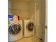 Bright laundry room with washer, dryer, and overhead storage at 477 Harvick Cir, Stockbridge, GA 30281