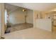 Open-concept room with tile and carpet flooring adjacent to kitchen area with a ceiling fan at 477 Harvick Cir, Stockbridge, GA 30281