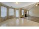 Bright living room with tile floors, vaulted ceiling, and natural light from windows and glass door at 477 Harvick Cir, Stockbridge, GA 30281