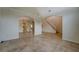 Spacious living room featuring neutral tile flooring, arched doorways, and natural light at 477 Harvick Cir, Stockbridge, GA 30281
