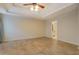 Spacious bedroom with tiled floors and tray ceiling, offering a serene and open atmosphere at 477 Harvick Cir, Stockbridge, GA 30281