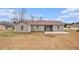 Exterior rear elevation view of home with backyard and concrete patio at 100 Hunters Keep Trce, Covington, GA 30014