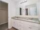 Bathroom with double vanity, granite countertop, dual mirrors, and ample cabinet space, a serene space at 100 Hunters Keep Trce, Covington, GA 30014